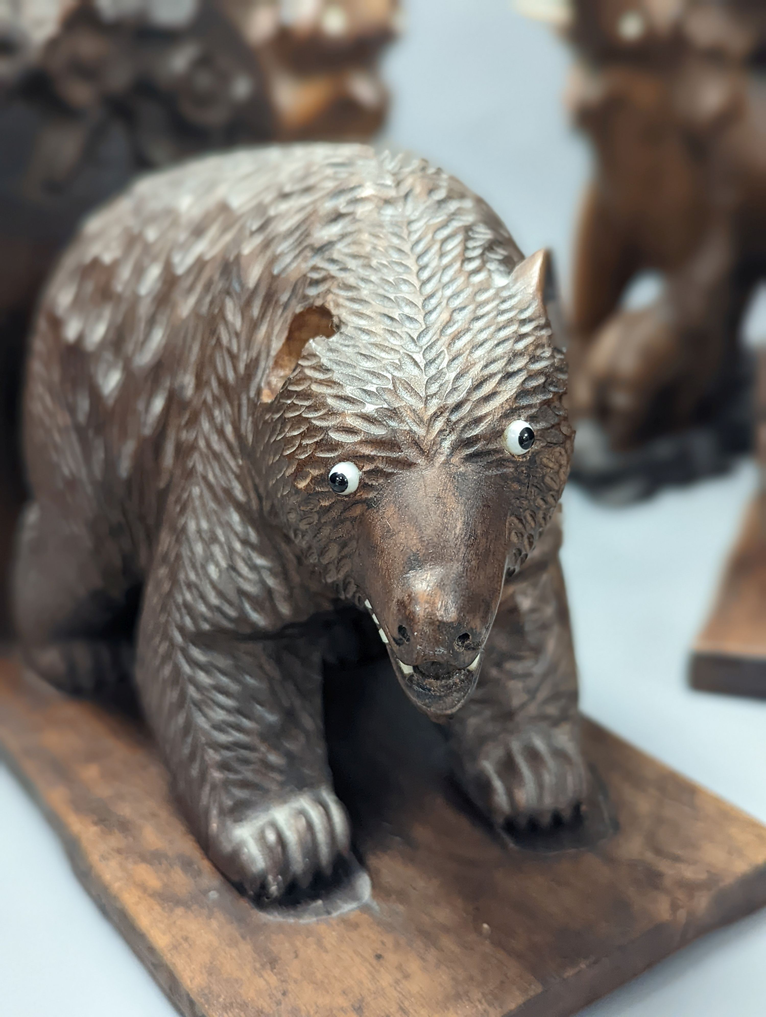 A pair of Chinese wood carvings figures on elephants, a pair of Chinese bear bookends, Chines figures 26 cms high.